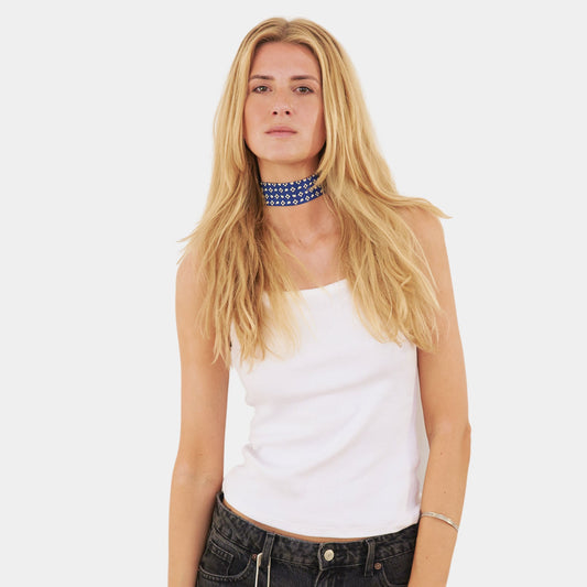model wearing a blue silk choker with a repeating geometric pattern of diamonds and ovals