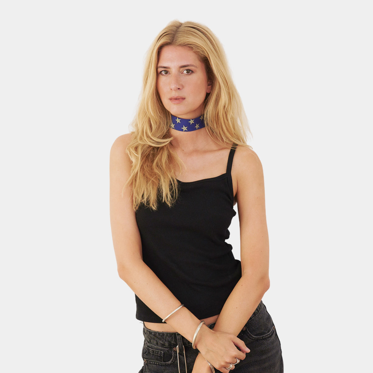 model wearing a blue silk choker with repeating white stars featuring striped detailing