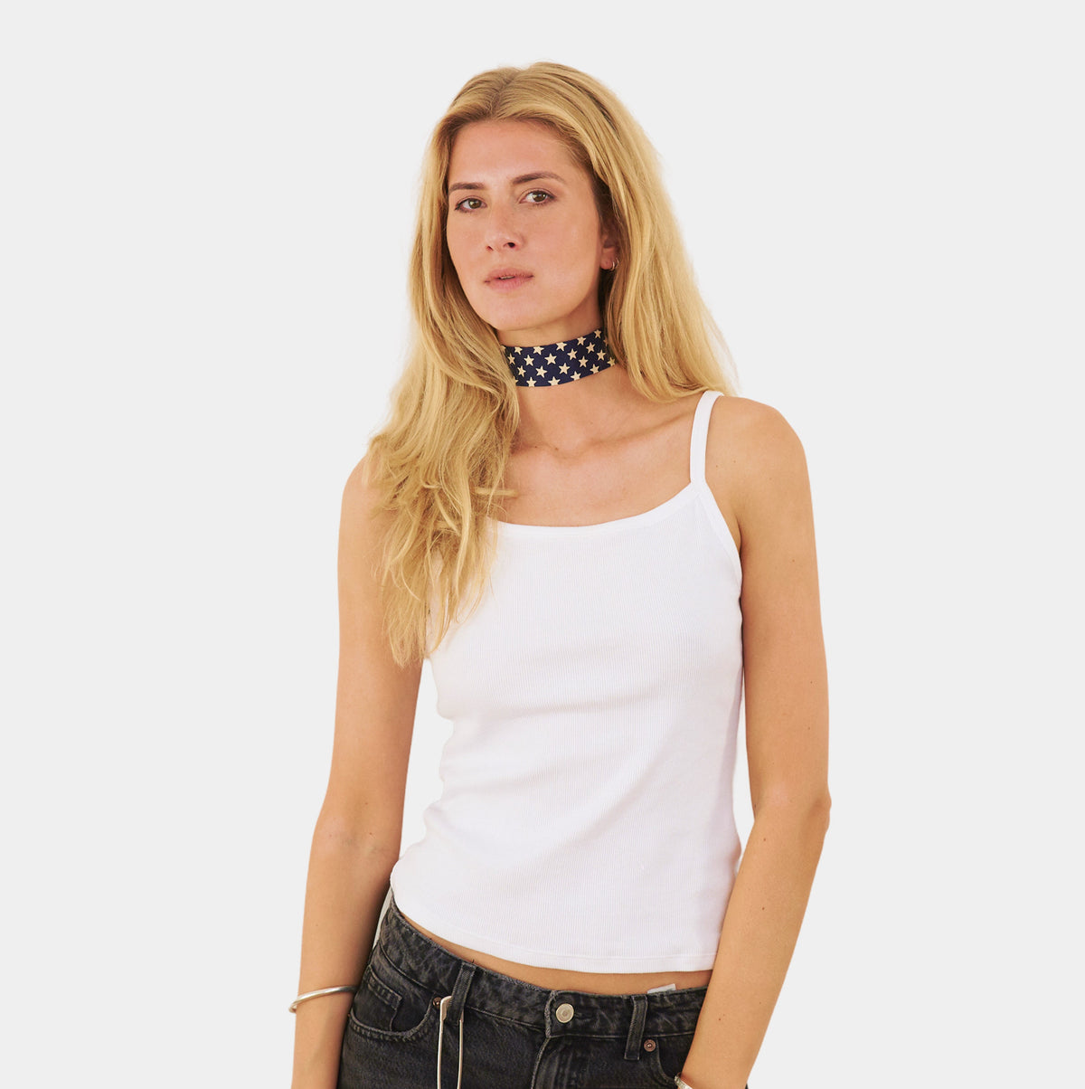model wearing a navy silk choker with a repeating white star pattern