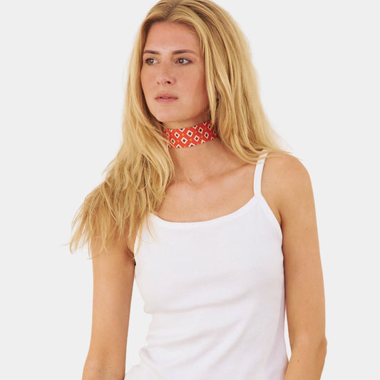 model wearing an orange silk choker with a geometric diamond pattern