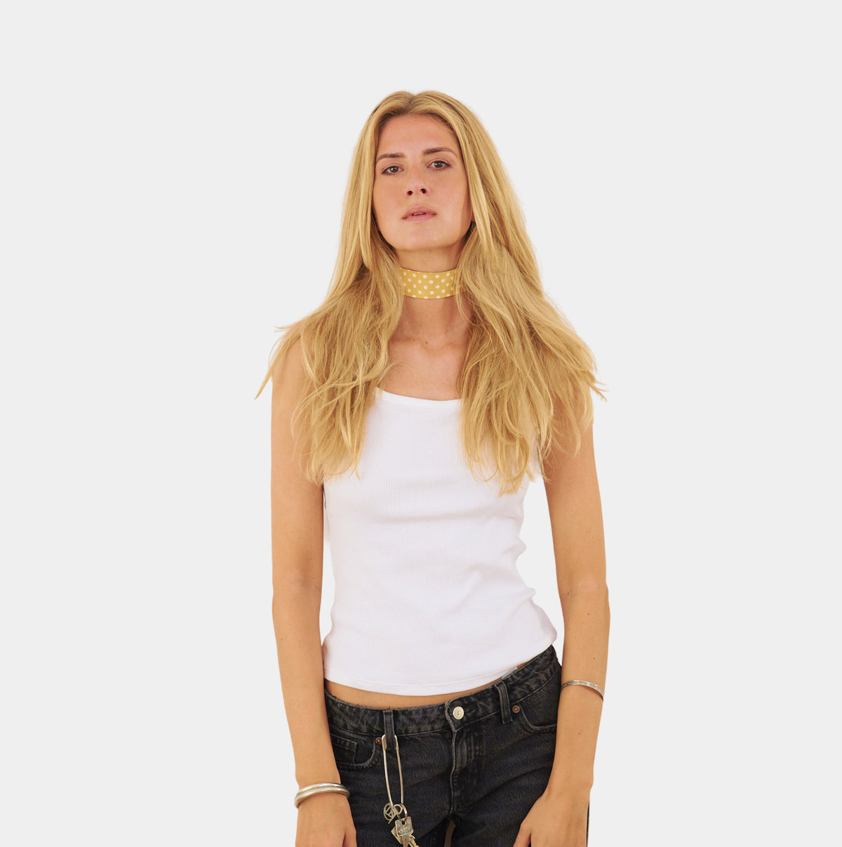 model wearing a yellow silk choker with repeating white polka dots