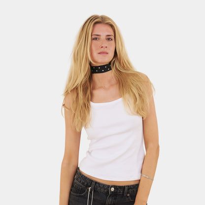 model wearing a black silk choker with repeating white polka dots