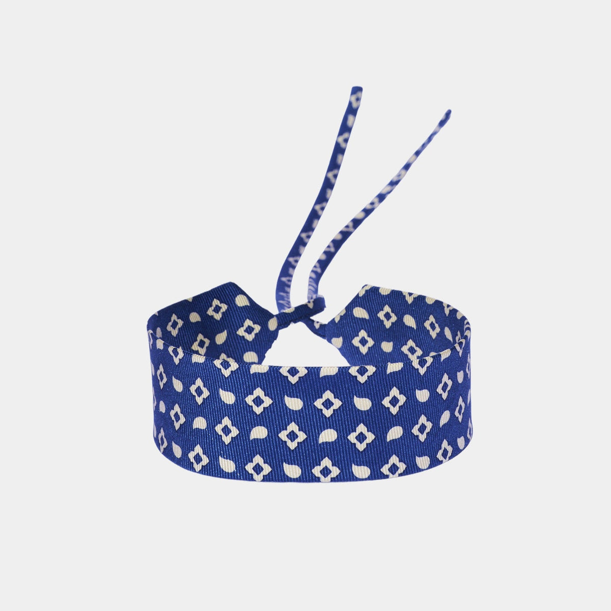 Blue silk choker with a repeating geometric pattern of diamonds and ovals