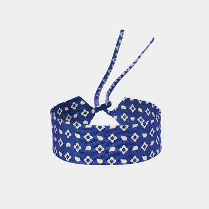 Blue silk choker with a repeating geometric pattern of diamonds and ovals