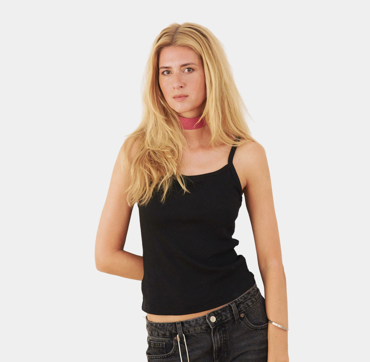 model wearing a bright red silk choker with a repeating white dot pattern