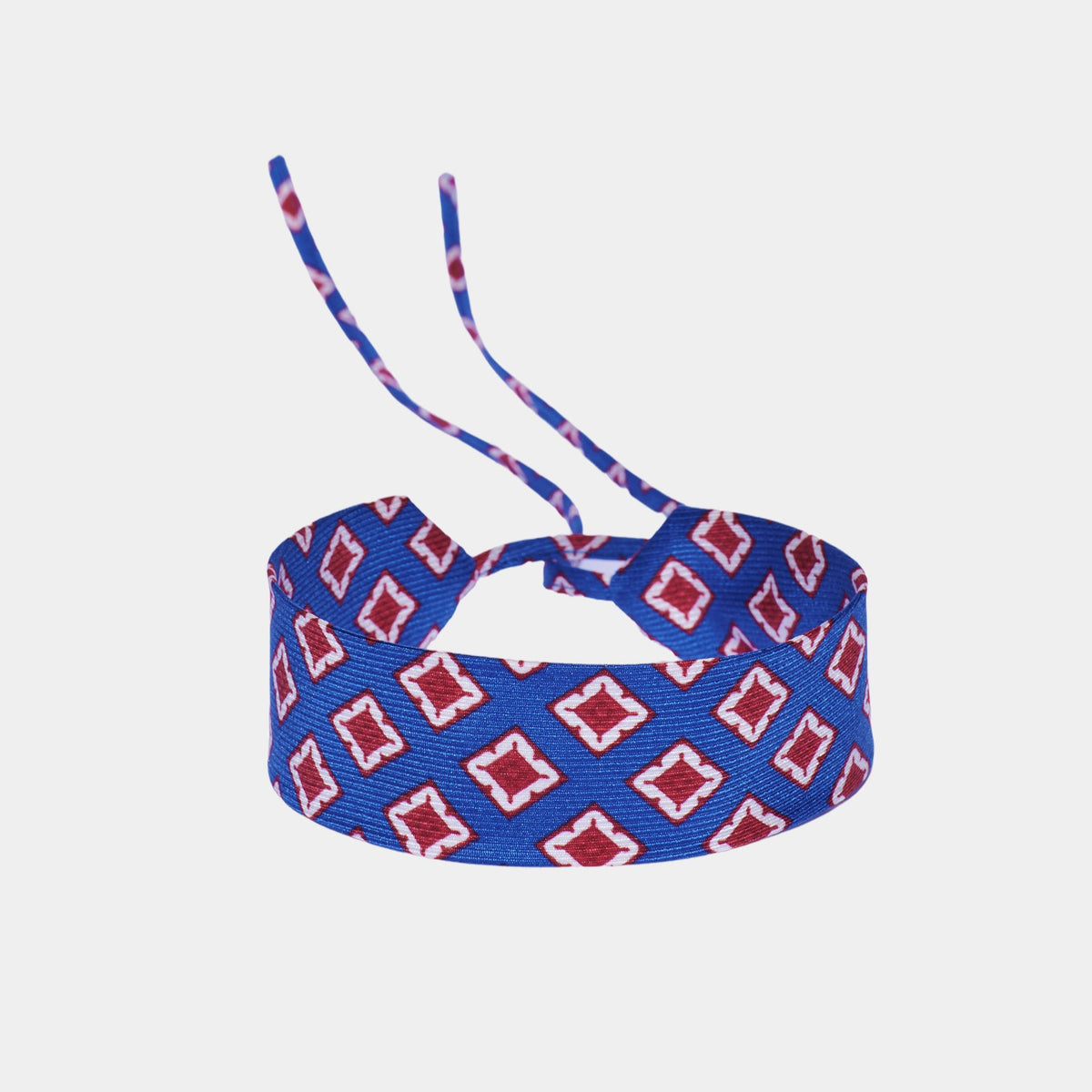 Cobalt blue silk choker with a repeating red and white geometric diamond pattern