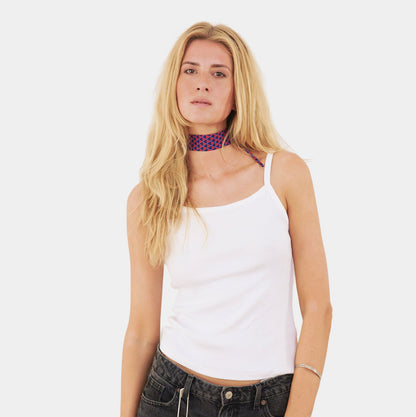 Model wearing a deep navy and red silk choker with a geometric triangle pattern