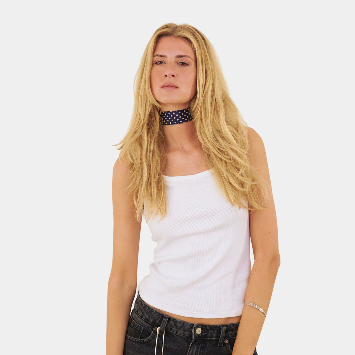 Model wearing an indigo blue silk choker with a dotted pattern