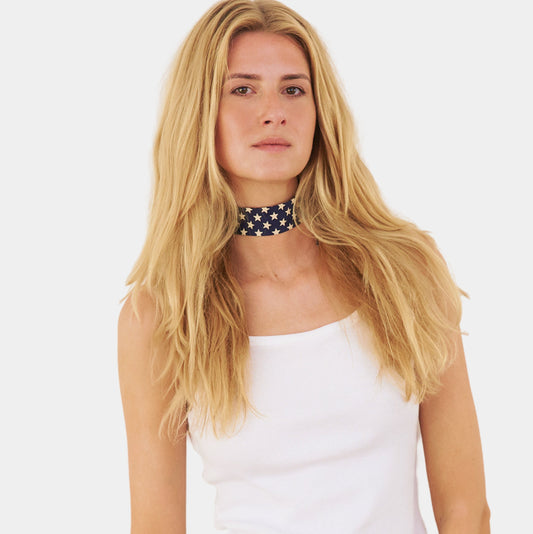 model wearing a navy silk choker with a repeating white star pattern