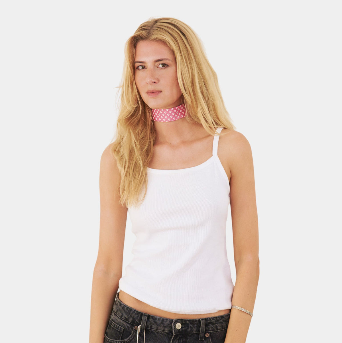model wearing a pink silk choker with a repeating white diamond pattern