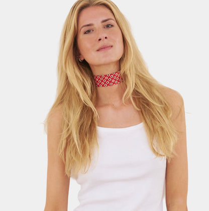 Model wearing a red silk choker with oval pattern