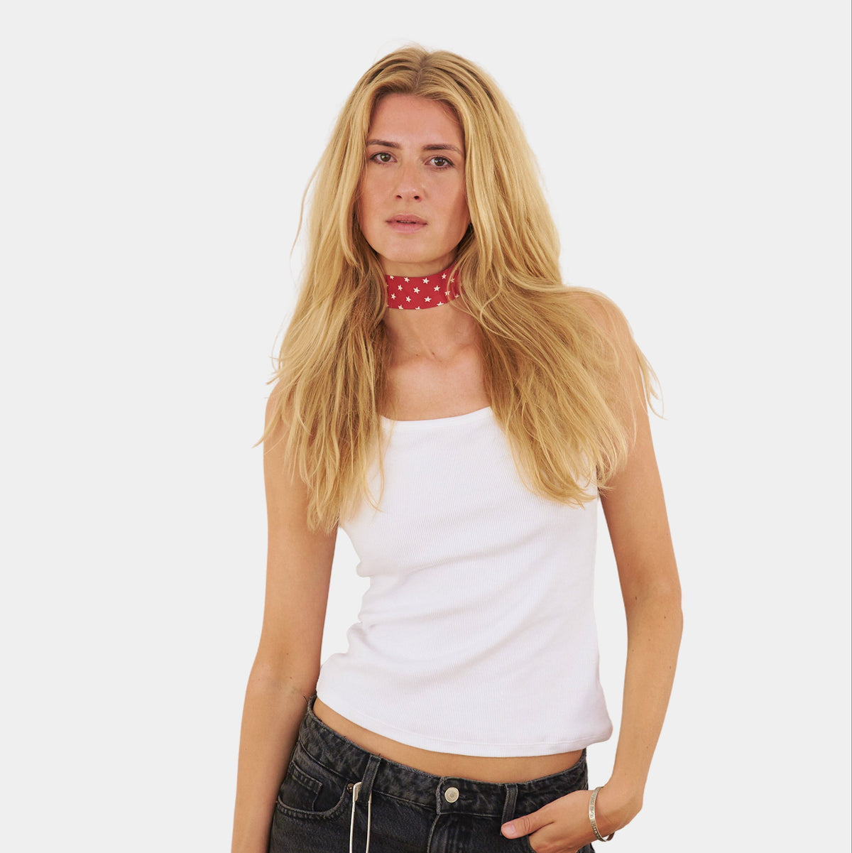 Model wearing a red silk choker with a repeating white star pattern