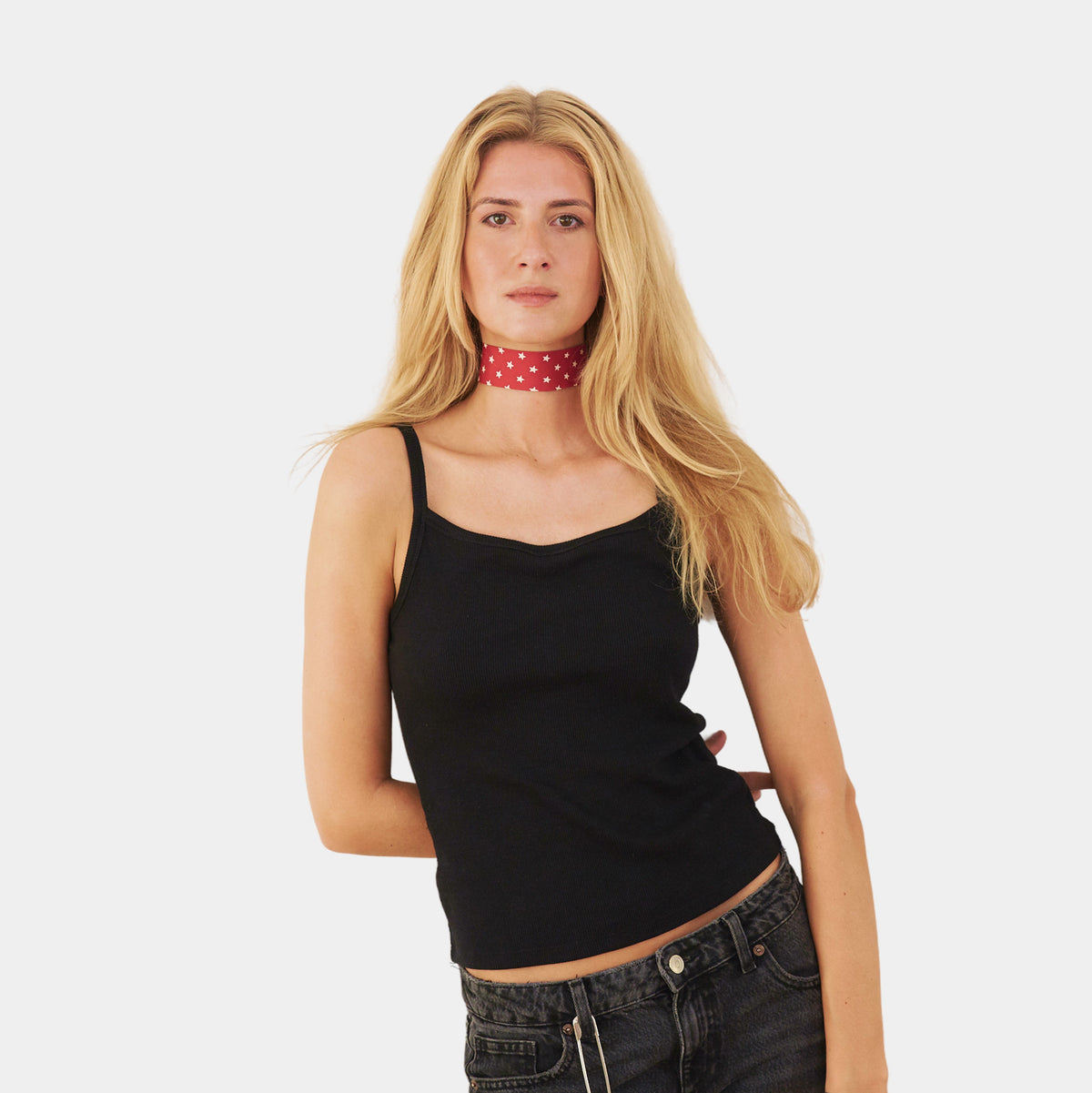 Model wearing a red silk choker with a repeating white star pattern