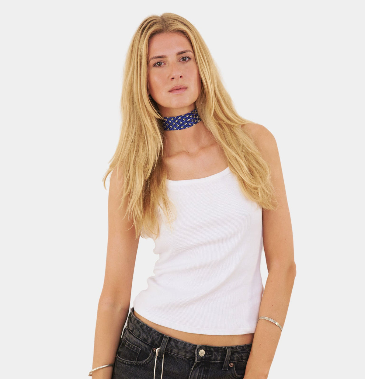 model wearing a sapphire blue silk choker with a repeating floral diamond pattern