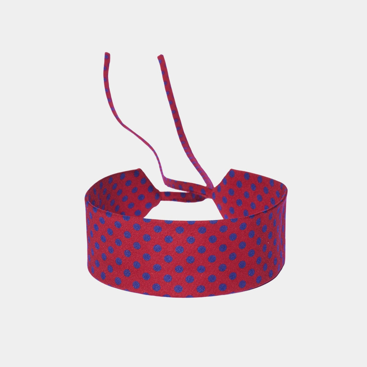 Scarlet red silk choker with a repeating blue polka dot pattern