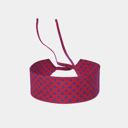 Scarlet red silk choker with a repeating blue polka dot pattern