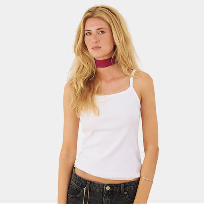 model wearing a scarlet red silk choker with a repeating blue polka dot pattern